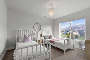 Bedroom with carpet flooring, a mountain view, a chandelier, and a residential view