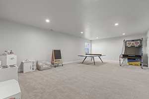 Recreation room featuring recessed lighting and light carpet