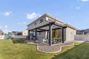 Back of house with a fenced backyard, a patio, a gate, and a pergola