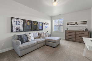 Carpeted living room with baseboards