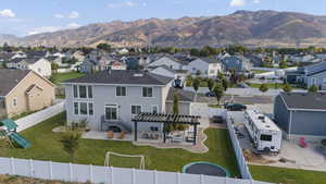 Aerial perspective of suburban area with a mountainous background