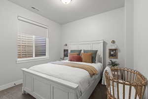 Bedroom featuring carpet floors and baseboards