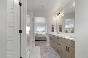 Primary Full bath with ensuite bath, double vanity, plenty of natural light, and a shower stall