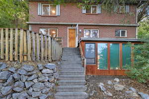 Doorway to property with brick siding