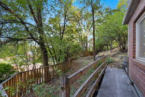 Wooden deck with a fenced backyard