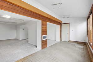 Spare room with light colored carpet and baseboards