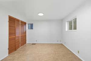 Unfurnished bedroom featuring a closet and baseboards