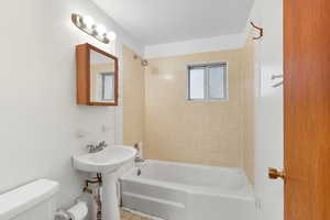 Full bathroom with shower / tub combination and toilet