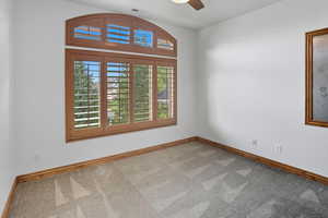 Spare room featuring light carpet and a ceiling fan