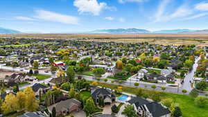 Aerial overview of property's location featuring nearby suburban area and a mountain backdrop
