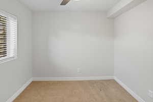 Spare room with light wood-style flooring and a ceiling fan