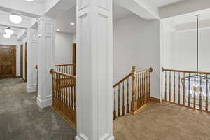 Corridor with carpet floors, an upstairs landing, and recessed lighting