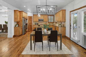 Dining area featuring a chandelier, light wood-style flooring, and recessed lighting
