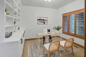 Office space featuring light wood-type flooring and baseboards