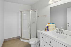 Bathroom with a stall shower, vanity, and light tile patterned floors