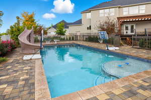 View of pool featuring a patio area and a water slide