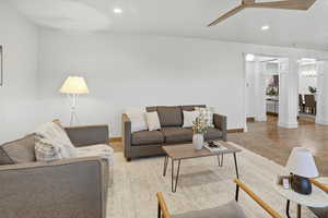 Living room with recessed lighting, a ceiling fan, and decorative columns