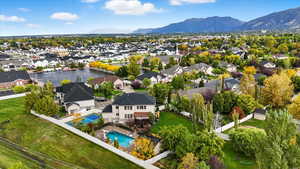 Aerial perspective of suburban area with a mountainous background and a pool area
