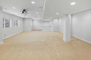 Basement with light colored carpet and recessed lighting