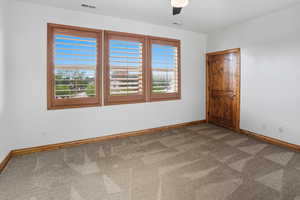 Unfurnished room with baseboards and light colored carpet