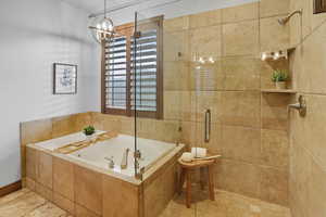 Bathroom featuring a shower stall and a bath