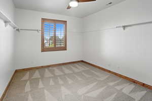 Unfurnished room featuring ceiling fan and light carpet