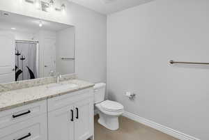 Full bathroom with vanity, light tile patterned flooring, and a shower with curtain