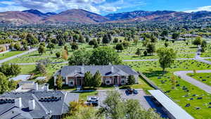 Aerial view of property and surrounding area with a mountain backdrop
