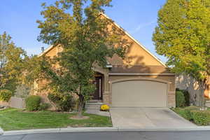 View of home,  two car garage, access to backyard on northside.