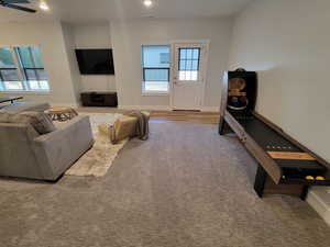 Living room featuring carpet flooring, ceiling fan, recessed lighting, and wood finished floors