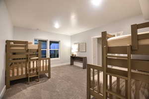 Carpeted bedroom featuring baseboards