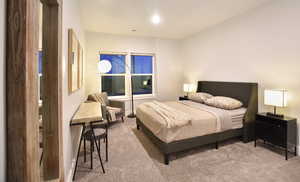 Bedroom featuring light colored carpet