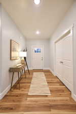 Entrance foyer with light wood-type flooring and recessed lighting