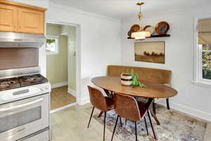 Dining room with baseboards and crown molding