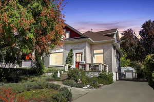 View of front of house featuring brick siding and a gate