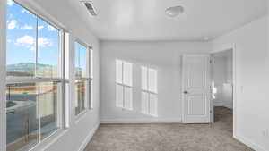 Spare room with light carpet and a mountain view