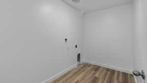 Laundry room featuring wood finished floors, electric dryer hookup, and hookup for a washing machine