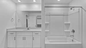 Full bath featuring shower / bathtub combination, vanity, a closet, and recessed lighting