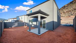 Back of property with a patio area, stucco siding, a mountain view, and a fenced backyard
