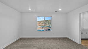 Spare room with light carpet and recessed lighting