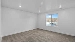 Unfurnished room with carpet flooring and recessed lighting