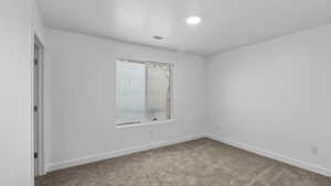 Unfurnished room featuring carpet flooring and baseboards