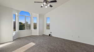 Unfurnished room with carpet, lofted ceiling, and a ceiling fan