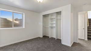 Unfurnished bedroom with carpet floors and a closet
