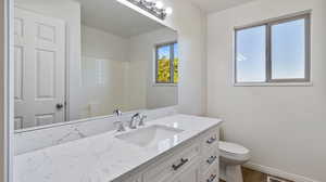 Full bathroom with vanity and wood finished floors