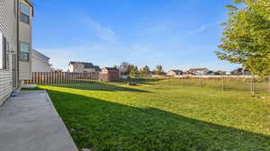 Fenced backyard featuring a residential view