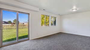 Carpeted spare room with baseboards