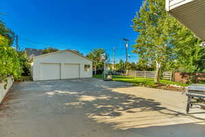 View of side of property with an outbuilding and a detached garage