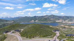 View of mountain backdrop featuring a nearby body of water