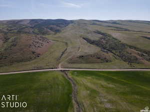 Aerial overview of property's location with a mountain backdrop and rural landscape